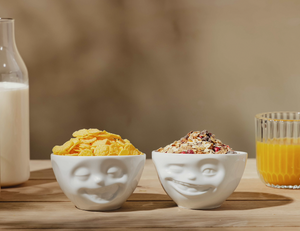 Set of two 6.5 oz. bowls in white from the TASSEN product family featuring sculpted Laughing and Winking faces.